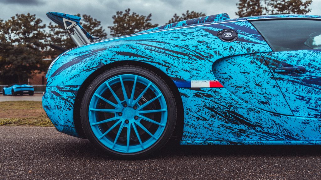 Gros plan Bugatti Veyron Grand Sport Vitesse 'POGATTI'. Livrée artistique bleue Haëtty, aileron et jante.